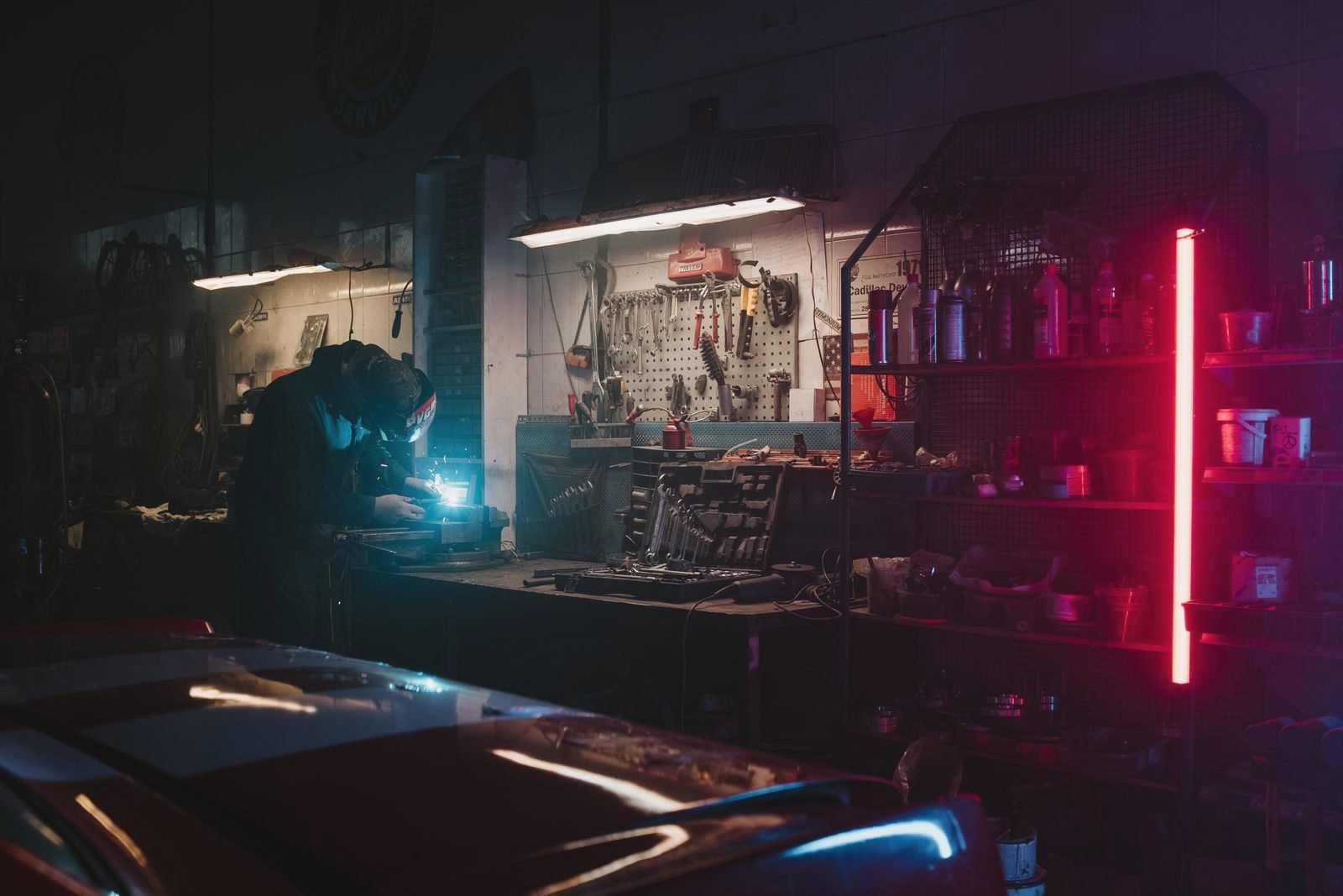 A repair shop interior lit low after dark